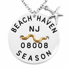 Load image into Gallery viewer, A silver round Beach Haven Beach tag pendant necklace engraved with 'BEACH HAVEN NJ 08008 SEASON' and a wavy gold accent, with a small silver starfish charm on a white background.