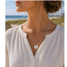 Load image into Gallery viewer, A woman at the beach wearing a necklace that has a starfish and beach badge pendant of Sea Isle, NJ