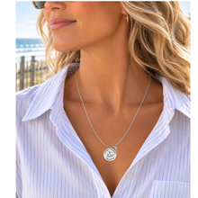 Load image into Gallery viewer, A woman at the beach wearing a necklace that has a starfish and beach badge pendant of Stone Harbor, NJ