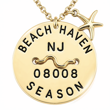 Load image into Gallery viewer, A gold-toned round Beach Tag pendant necklace engraved with 'BEACH HAVEN NJ 08008 SEASON' and a wavy line, with a small starfish charm on a matching chain against a white background.
