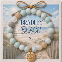 Load image into Gallery viewer, Carded Bradley Beach Goldtone Beach Tag Amazonite Beaded Bracelet with twine bow
