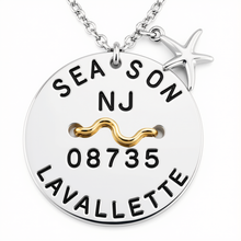 Load image into Gallery viewer, A silver round beach tag pendant necklace with a starfish charm, featuring custom engraved text 'SEA SON NJ 08735 LAVALLETTE' and a gold wave accent on a white background.
