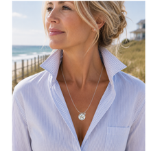Load image into Gallery viewer, A woman at the beach wearing a necklace that has a starfish and beach badge pendant of Long Branch, NJ
