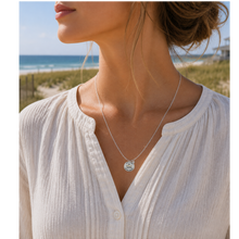 Load image into Gallery viewer, A woman at the beach wearing a necklace that has a starfish and beach badge pendant of Loveladies, NJ
