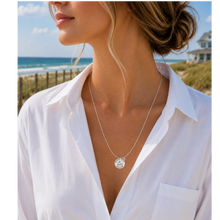Load image into Gallery viewer, A woman at the beach wearing a necklace that has a starfish and beach badge pendant of Ocean City, NJ

