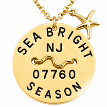 Load image into Gallery viewer, A gold-toned round beach tag pendant necklace engraved with 'SEA BRIGHT NJ 07760 SEASON' and a starfish charm, shown on a white background.

